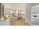 Modern kitchen with white cabinets, granite countertops, and a view to the breakfast table and bedroom at 18324 Cropside Trl, Lakewood Ranch, FL 34211