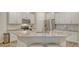 An island in the kitchen has a sink and granite counters with bar stool seating at 18324 Cropside Trl, Lakewood Ranch, FL 34211