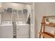 Bright laundry room with modern machines and wood storage shelves at 18324 Cropside Trl, Lakewood Ranch, FL 34211