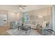 Comfortable living room with neutral tones, a ceiling fan, and lots of natural light at 18324 Cropside Trl, Lakewood Ranch, FL 34211