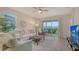 Bright living room with comfortable seating, stylish decor, and a sliding glass door to the outside at 18324 Cropside Trl, Lakewood Ranch, FL 34211