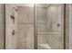 Detailed shower showcasing tile walls, rainfall shower head, and glass door enclosure at 18324 Cropside Trl, Lakewood Ranch, FL 34211