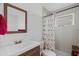 The cozy bathroom features a light-colored vanity and a shower with a flamingo curtain at 202 Bedford Trl # 120, Sun City Center, FL 33573