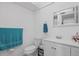 A bright bathroom with vanity sink, toilet and shower featuring a tropical curtain at 202 Bedford Trl # 120, Sun City Center, FL 33573