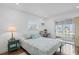 Cozy bedroom with a window view, desk and sliding glass door to an enclosed lanai at 202 Bedford Trl # 120, Sun City Center, FL 33573