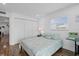 This bedroom features a large closet, a window, and a colorful comforter on the bed at 202 Bedford Trl # 120, Sun City Center, FL 33573