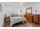 Bright bedroom with hardwood floors, ceiling fan, and a light-colored bedspread at 202 Bedford Trl # 120, Sun City Center, FL 33573
