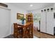 Cozy dining area featuring a wooden table set, complemented by natural lighting and stylish decor at 202 Bedford Trl # 120, Sun City Center, FL 33573