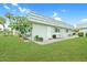 Charming single-story home with well-maintained lawn and inviting front patio seating area at 202 Bedford Trl # 120, Sun City Center, FL 33573