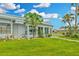 Bright sunroom with large windows and manicured lawn at 202 Bedford Trl # 120, Sun City Center, FL 33573