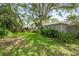 Expansive backyard with mature trees offering shade and a well-maintained lawn at 2204 67Th W St, Bradenton, FL 34209