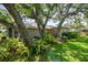 Lush backyard with mature trees and tropical plants offering shade and privacy at 2204 67Th W St, Bradenton, FL 34209