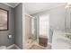 Well-lit bathroom featuring a shower with glass door and a double sink vanity at 2204 67Th W St, Bradenton, FL 34209