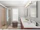 Bright bathroom featuring a shower with glass door and a double sink vanity at 2204 67Th W St, Bradenton, FL 34209