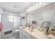 Clean bathroom with shower-tub combo, single vanity, and decorative wallpaper at 2204 67Th W St, Bradenton, FL 34209