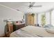 Bright bedroom featuring a ceiling fan, neutral walls, and a large wardrobe with natural light at 2204 67Th W St, Bradenton, FL 34209