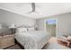 Comfortable bedroom featuring hardwood floors, patio access, and a ceiling fan at 2204 67Th W St, Bradenton, FL 34209