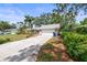Front exterior featuring a wide driveway, attached garage, and well-manicured landscaping at 2204 67Th W St, Bradenton, FL 34209