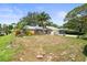 Spacious front yard with mature trees and lush landscaping surrounding this well-maintained home at 2204 67Th W St, Bradenton, FL 34209