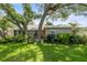 Charming single-story home with well-maintained lawn, mature trees, and lush landscaping at 2204 67Th W St, Bradenton, FL 34209