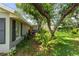 Side of home featuring lush landscaping, trees and green lawn at 2204 67Th W St, Bradenton, FL 34209