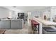 Open-concept living room with modern furniture and a kitchen bar for entertaining at 2204 67Th W St, Bradenton, FL 34209