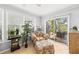 Relaxing sun room offers neutral tones and natural light with sliding door to the exterior at 2204 67Th W St, Bradenton, FL 34209
