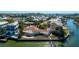 Waterfront home featuring a dock, backyard patio, and lush tropical landscaping at 236 S Harbor Dr, Holmes Beach, FL 34217