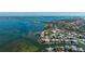 Waterfront home with a dock surrounded by lush landscaping and coastal charm at 236 S Harbor Dr, Holmes Beach, FL 34217