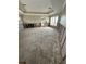 Bright living room is ready for a design vision; a blank canvas with neutral walls, multiple windows, and unique trey ceiling at 236 S Harbor Dr, Holmes Beach, FL 34217