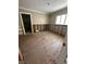 Renovate this living room and make it your own; bright with a large window and entry door to the left at 236 S Harbor Dr, Holmes Beach, FL 34217