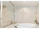 Bright bathroom featuring a jacuzzi tub, decorative tile surround and large vanity mirror at 2825 Terra Ceia Bay Blvd # 1804, Palmetto, FL 34221