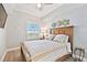 Stylish bedroom with light wood floors and modern decor, with a beach view from the window at 2825 Terra Ceia Bay Blvd # 1804, Palmetto, FL 34221