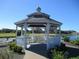 Charming white gazebo overlooking a serene pond and lush green golf course, perfect for relaxation at 2825 Terra Ceia Bay Blvd # 1804, Palmetto, FL 34221