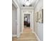 Hallway featuring wood-look flooring, neutral paint, and decorative wall art; bright and airy at 2825 Terra Ceia Bay Blvd # 1804, Palmetto, FL 34221