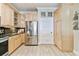 Bright kitchen featuring stainless steel refrigerator, custom cabinetry, and tile flooring at 2825 Terra Ceia Bay Blvd # 1804, Palmetto, FL 34221