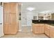 Kitchen boasting natural wood cabinetry and granite countertops, creating a warm and inviting space at 2825 Terra Ceia Bay Blvd # 1804, Palmetto, FL 34221