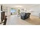 Bright living room featuring a large leather sofa set, wood floors, and a sliding glass door to the balcony at 2825 Terra Ceia Bay Blvd # 1804, Palmetto, FL 34221