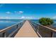 Scenic view of a long wooden pier extending into a tranquil bay under a clear blue sky with scattered clouds at 2825 Terra Ceia Bay Blvd # 1804, Palmetto, FL 34221