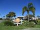 Entrance sign for Back Bay Grill with lush landscaping and palm trees under a clear blue sky at 2825 Terra Ceia Bay Blvd # 1804, Palmetto, FL 34221