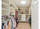 Spacious walk-in closet with custom shelving and wooden floors at 2825 Terra Ceia Bay Blvd # 1804, Palmetto, FL 34221