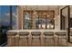 A stylish bar area with marble countertops, gold accents, and an open shelving design for displaying glassware and beverages at 290 Cocoanut Ave # 8B, Sarasota, FL 34236