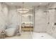 Luxurious bathroom with marble walls, a soaking tub, and a spacious walk-in shower at 290 Cocoanut Ave # 8B, Sarasota, FL 34236