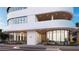 A modern building entrance showcasing sleek architecture, lush landscaping, and accessibility features at 290 Cocoanut Ave # 8B, Sarasota, FL 34236