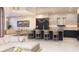 Bright, open kitchen with modern barstool seating, sleek countertops, and contemporary lighting at 290 Cocoanut Ave # 8B, Sarasota, FL 34236