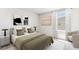 Relaxing bedroom with coordinating lamps, neutral tones, modern art, and a view to ensure a calming ambiance at 3219 Bitterroot Ln, Lakewood Ranch, FL 34211