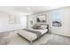 The neutral bedroom offers natural light and serene ambiance from the coordinating bedside tables to the modern artwork at 3219 Bitterroot Ln, Lakewood Ranch, FL 34211