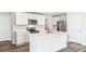 Modern kitchen featuring stainless steel appliances, island, and white cabinetry with marble countertops at 3219 Bitterroot Ln, Lakewood Ranch, FL 34211