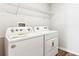 Functional laundry room with modern appliances and ample shelving for storage and organization at 3219 Bitterroot Ln, Lakewood Ranch, FL 34211