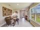 Dining room with table, chairs, and bench, decorative wood art, and a large window with natural light at 3278 Rock Sound St, Bradenton, FL 34208